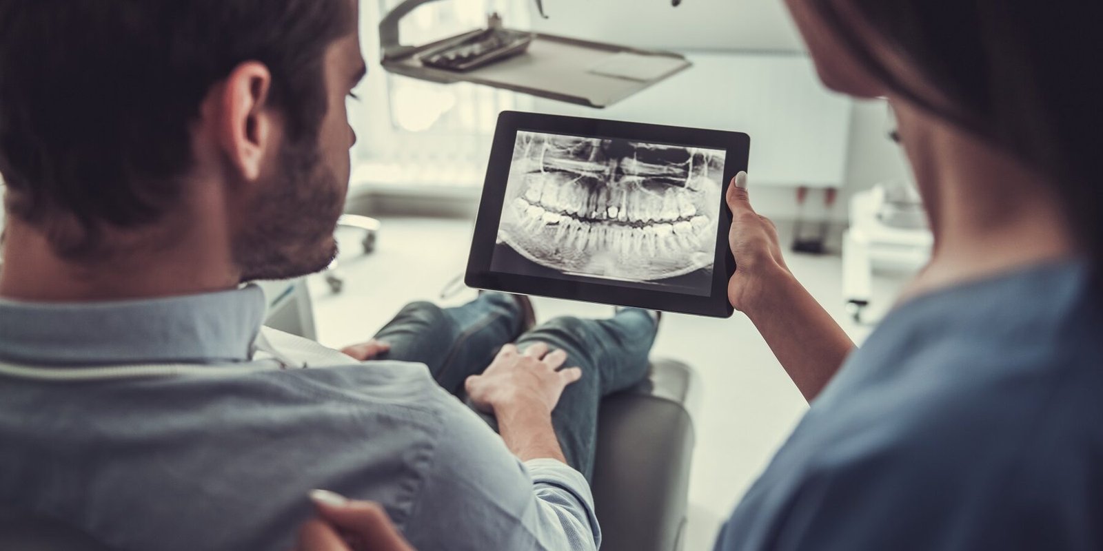 Immagine dottoressa che mostra lastra dentale